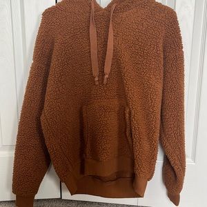Brown fluffy hoodie and size medium.